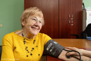 An older woman sits in a medical room in Riga, engaged in conversation with her doctor. Health risk assessment of air pollution should include morbidity outcomes to better inform on the true burden of disease from air pollution