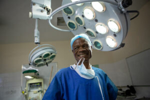 Zimbabwe, doctor standing under solar lights in theatre - Solar For Health Project UNDP. Health-care facility electrification provides the necessary lighting for safe childbirth.