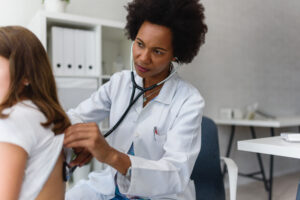 Doctor examining child with stethoscope.